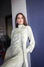 Close-up of Pastello Mint dress showing high neck detail, floral burnout fabric texture, and pearl gold brooch.